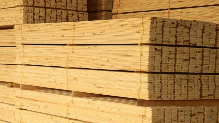 A bundle of 2x4 Dimensional Lumber stacked on top of more wood