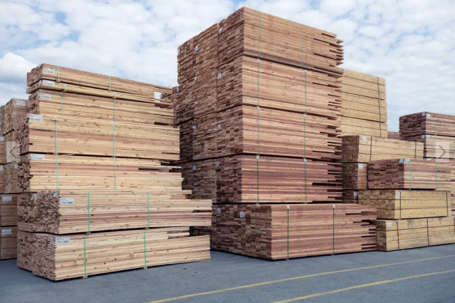 Stacks of dimensional lumber showcasing green wood and KDHT wood