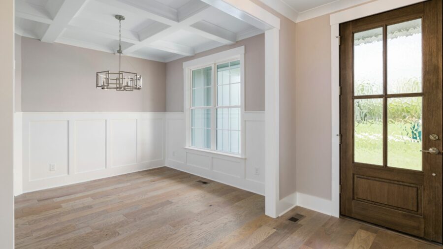 A well-lit room with white MDF closets and a window, emphasizing a minimalist and elegant home interior.