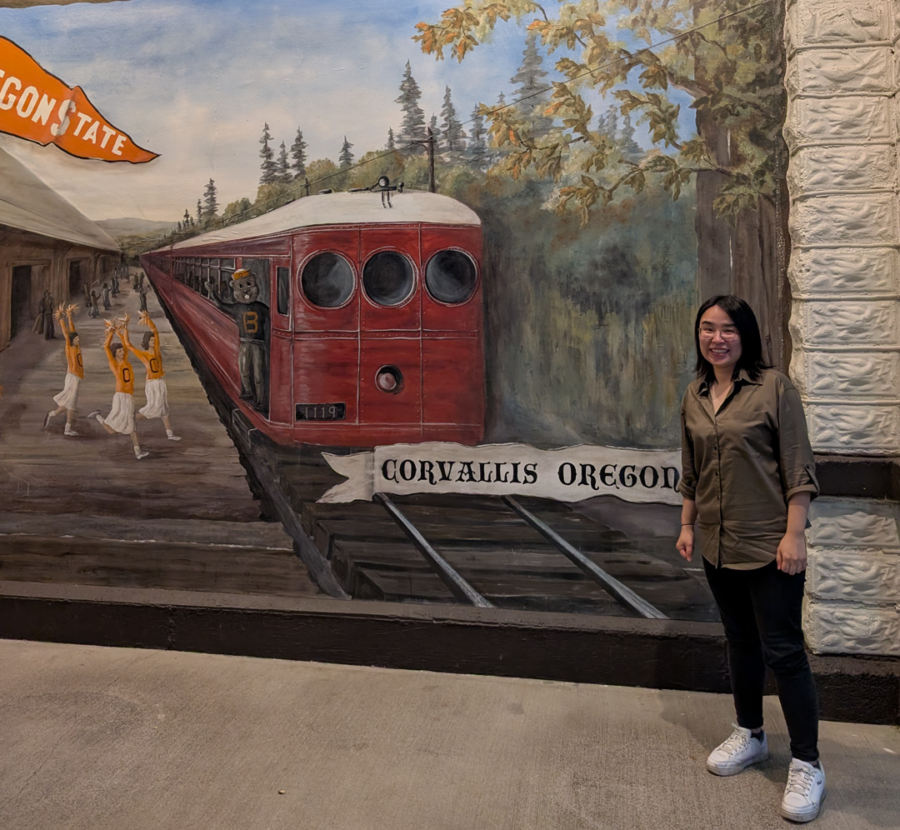Rita Chan in front of a decorative mural