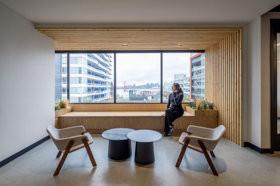 A woman in front of a window on the phone