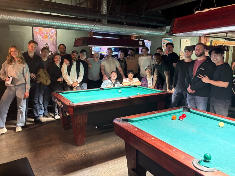 Our team standing around a pool table