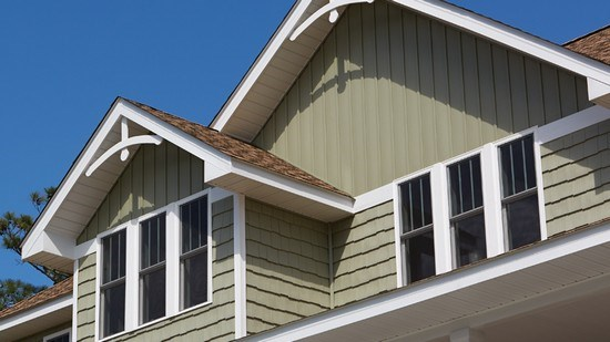Close up of the fascia and siding of a green cedar house
